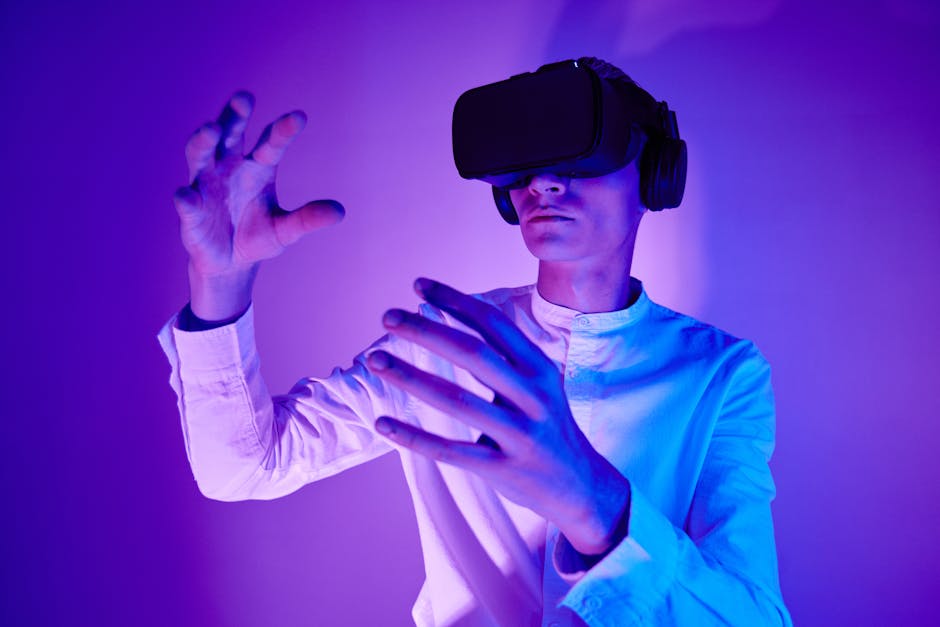 A man wearing VR goggles interacts with a virtual environment in a studio shot with vibrant lighting.