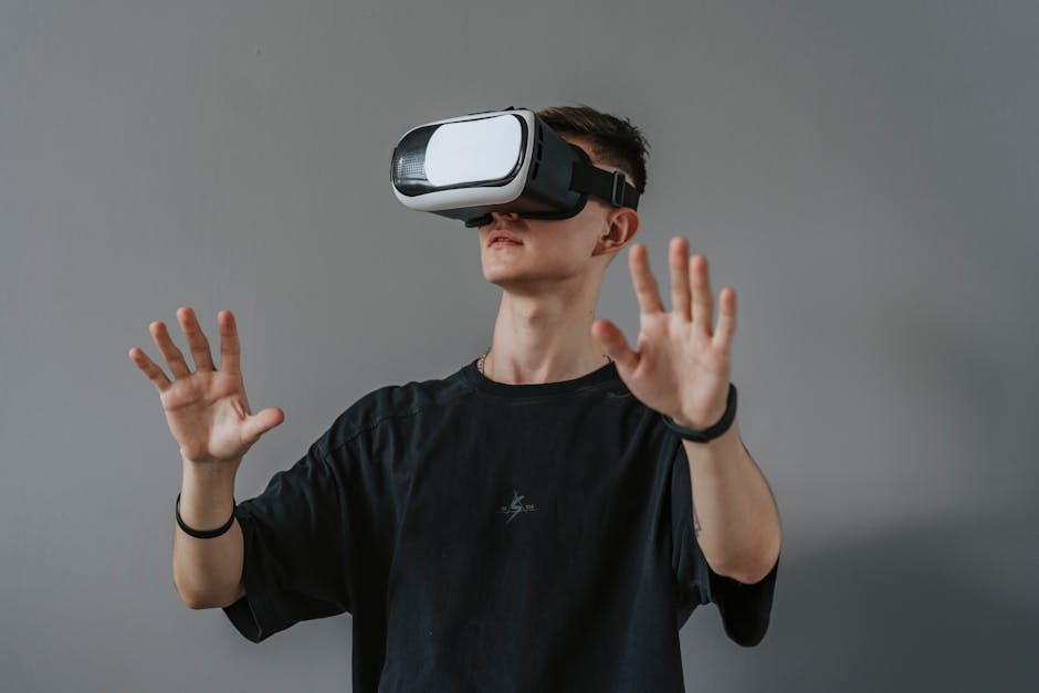 Young man explores virtual reality with VR headset, hands raised.